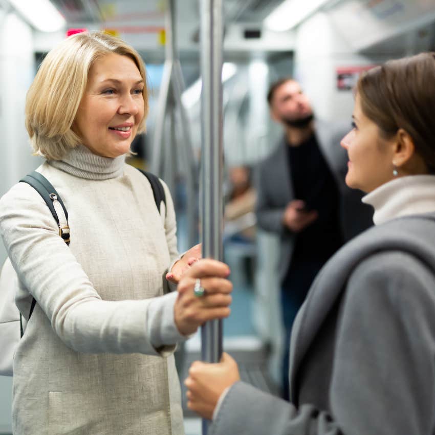happy woman feels seen after talking to stranger on subway
