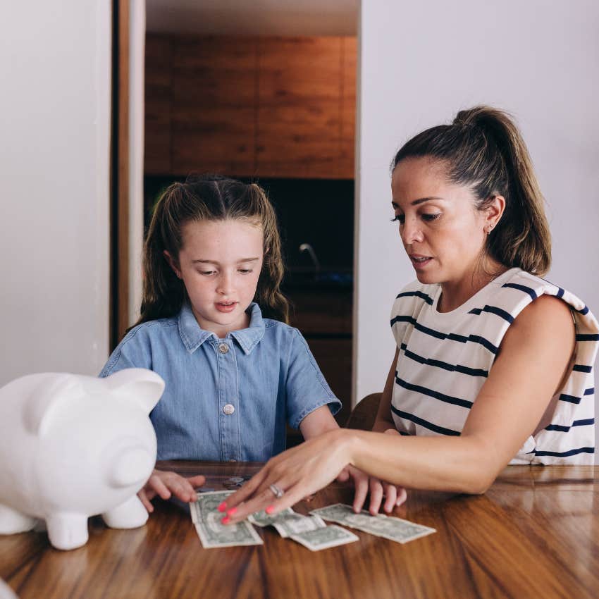 mom teaching her kid to save money for later