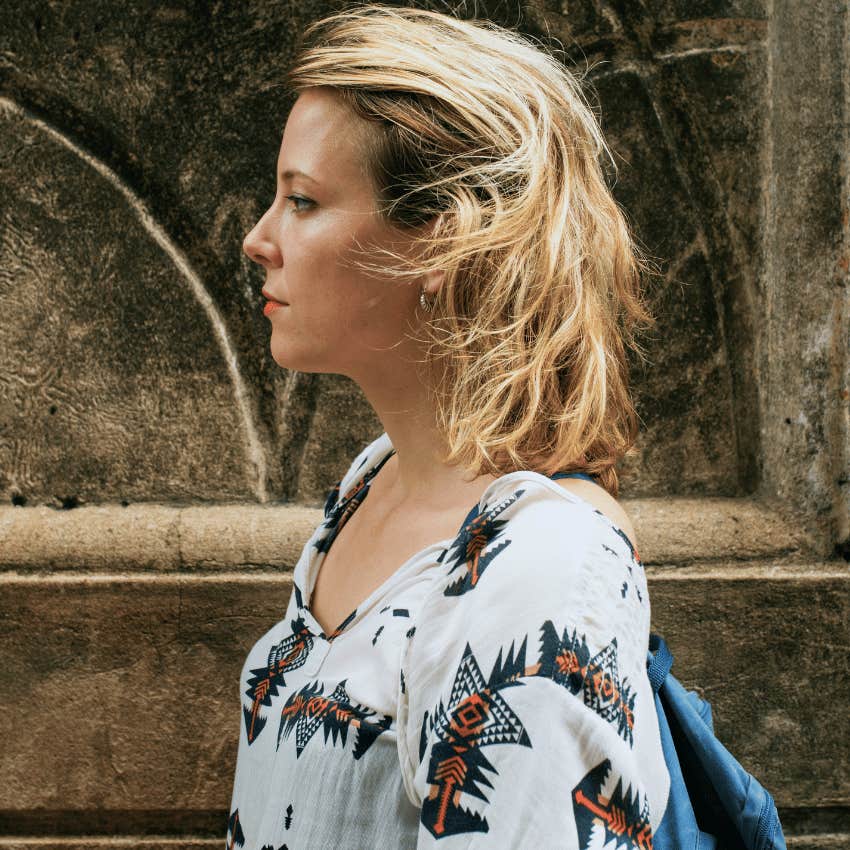 Serious woman who didn't get love she needed avoids eye contact