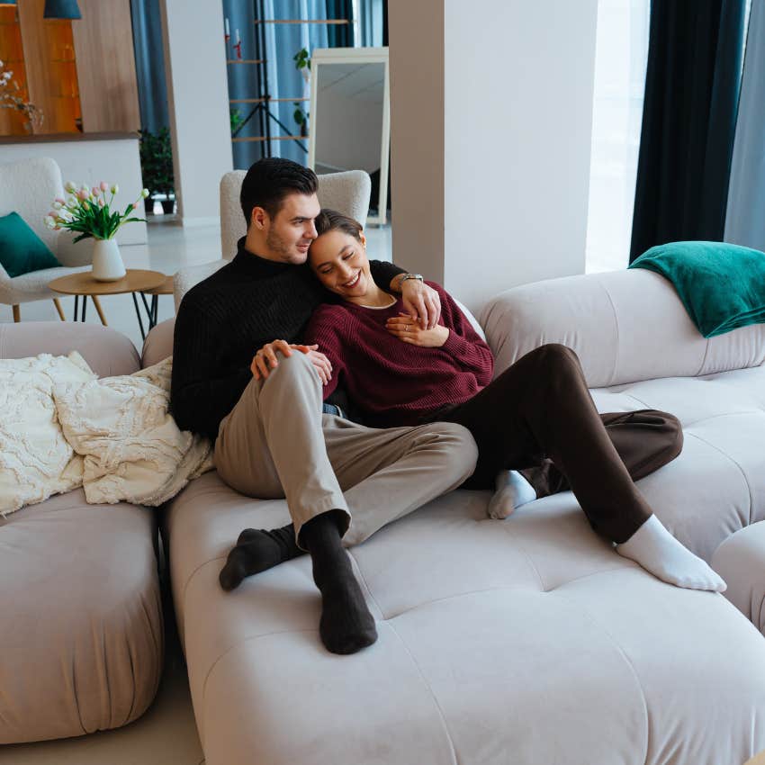 unmarried millennial couple living together snuggling