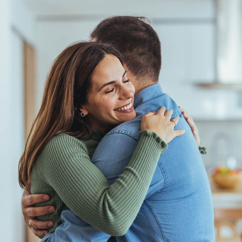 trustworthy woman showing empathy to man hugging him