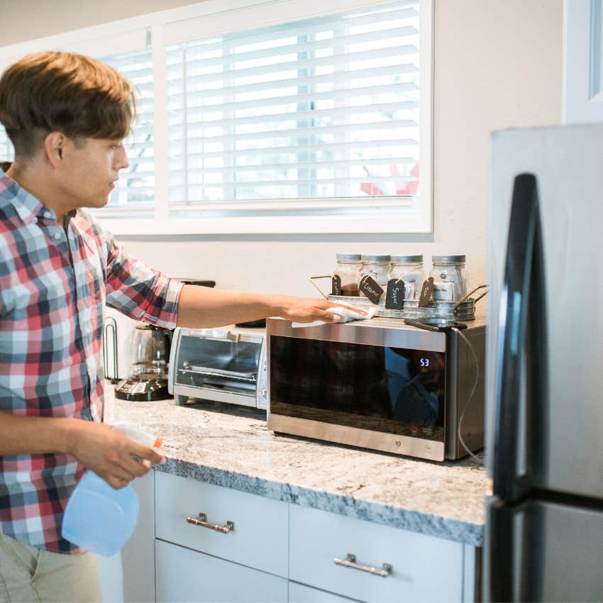 Young adult easily replacing a broken household appliance without worrying about the unexpected expense