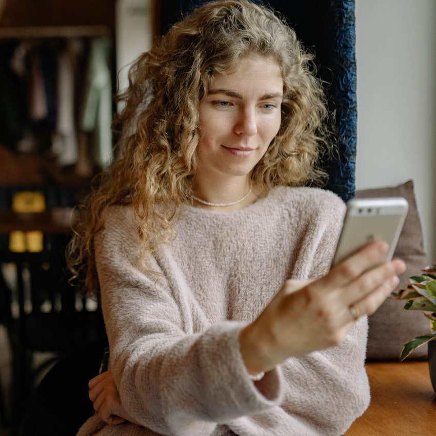 woman looking at tiktok on her phone