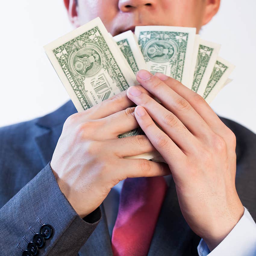 man showing off his cash
