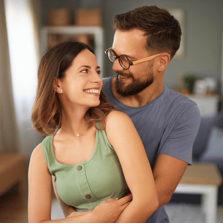smiling couple deep in love hugging each other close