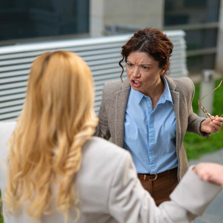 awkward annoyed woman yelling calm down in an argument with a friend