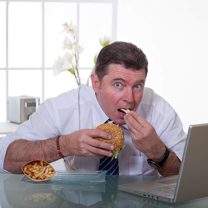 businessman eating fast food at work
