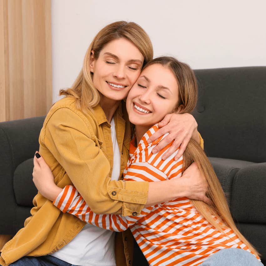 supportive mom hugging teen girl close