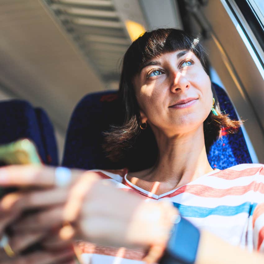 happy single woman riding the train