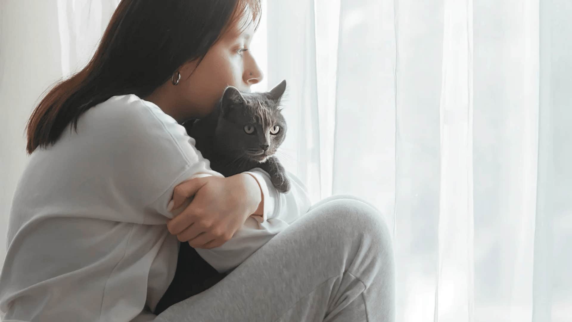 mentally strong woman holding cat aware of her place in the world