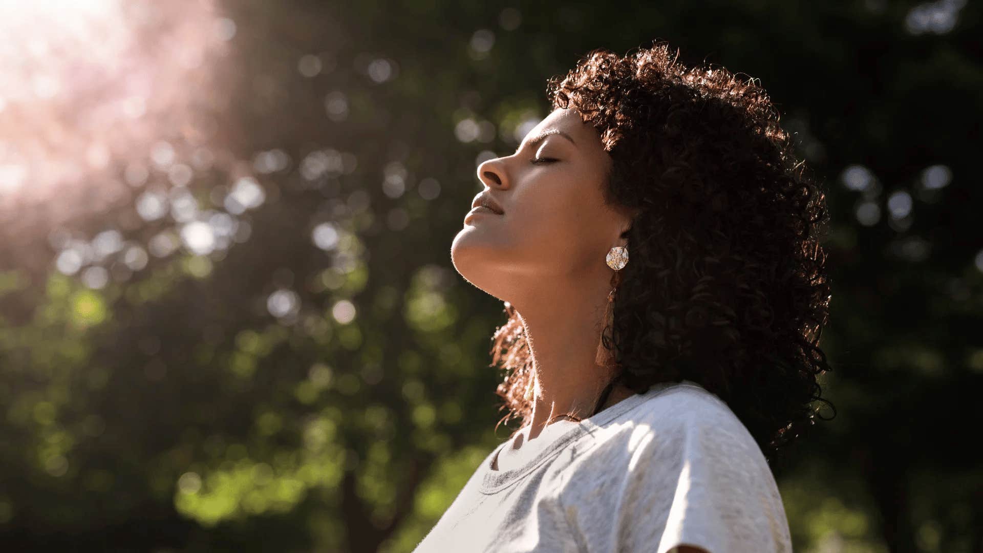 mentally strong woman with her fact toward the sun doesn't try to fix herself