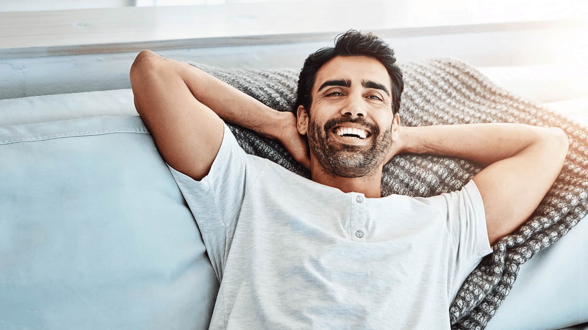 mentally strong man smiling because he understands the gap between thoughts and behavior