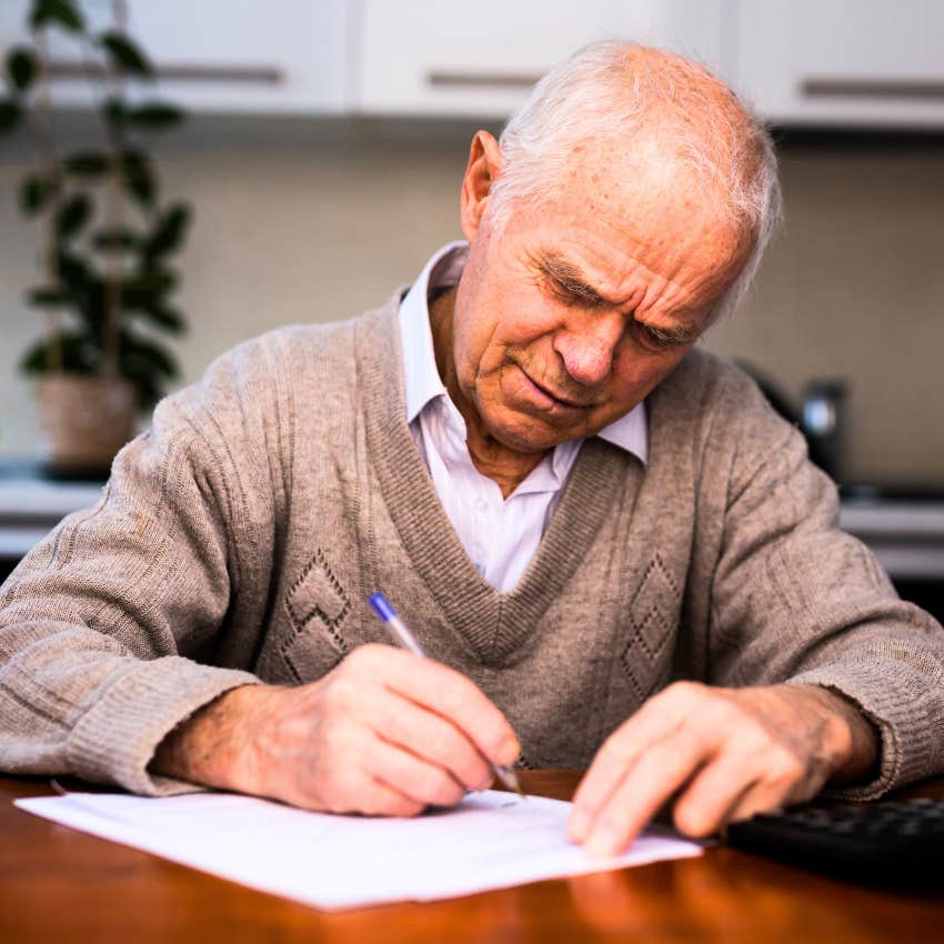 older man writing handwritten notes and letters