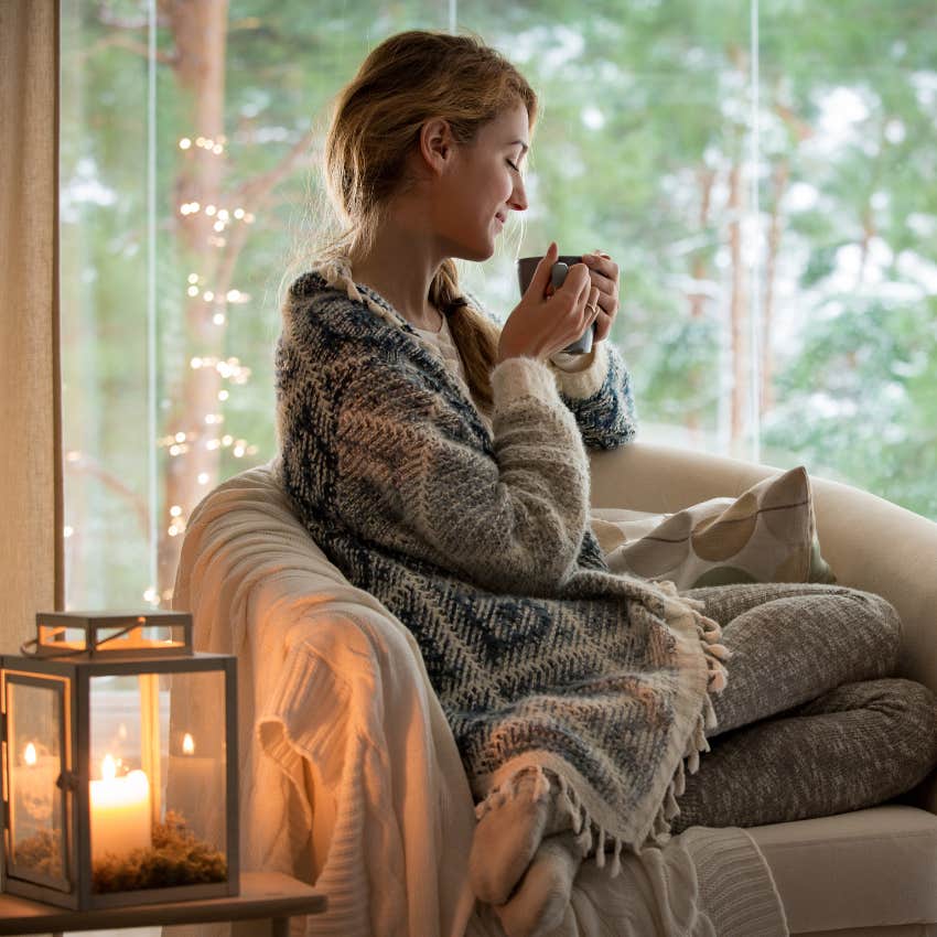 woman who loves peace and quiet sitting next to a candle