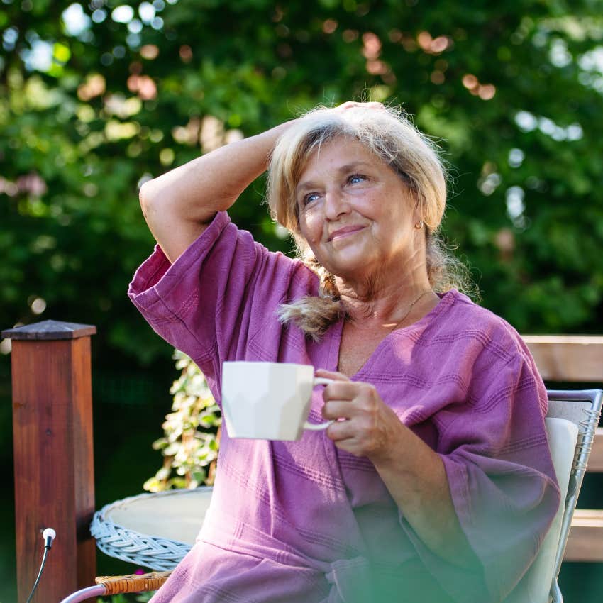 happy gen x woman enjoying her backyard who has stopped keeping up with the joneses