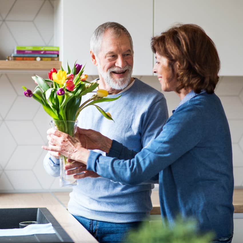 couple with great taste putting fresh flowers in their home
