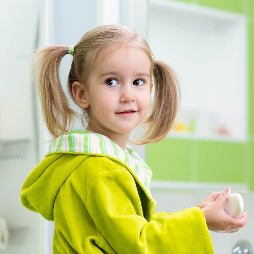 little girl about to get her mouth washed out with soap