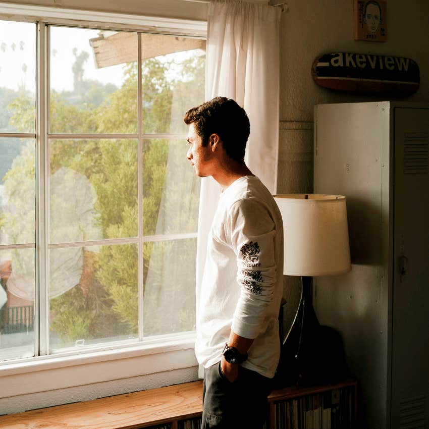 thoughtful man looking out of window