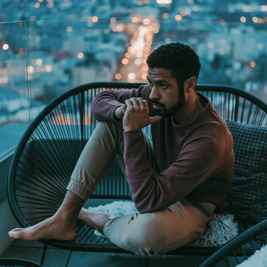 thoughtful man sitting alone on a balcony