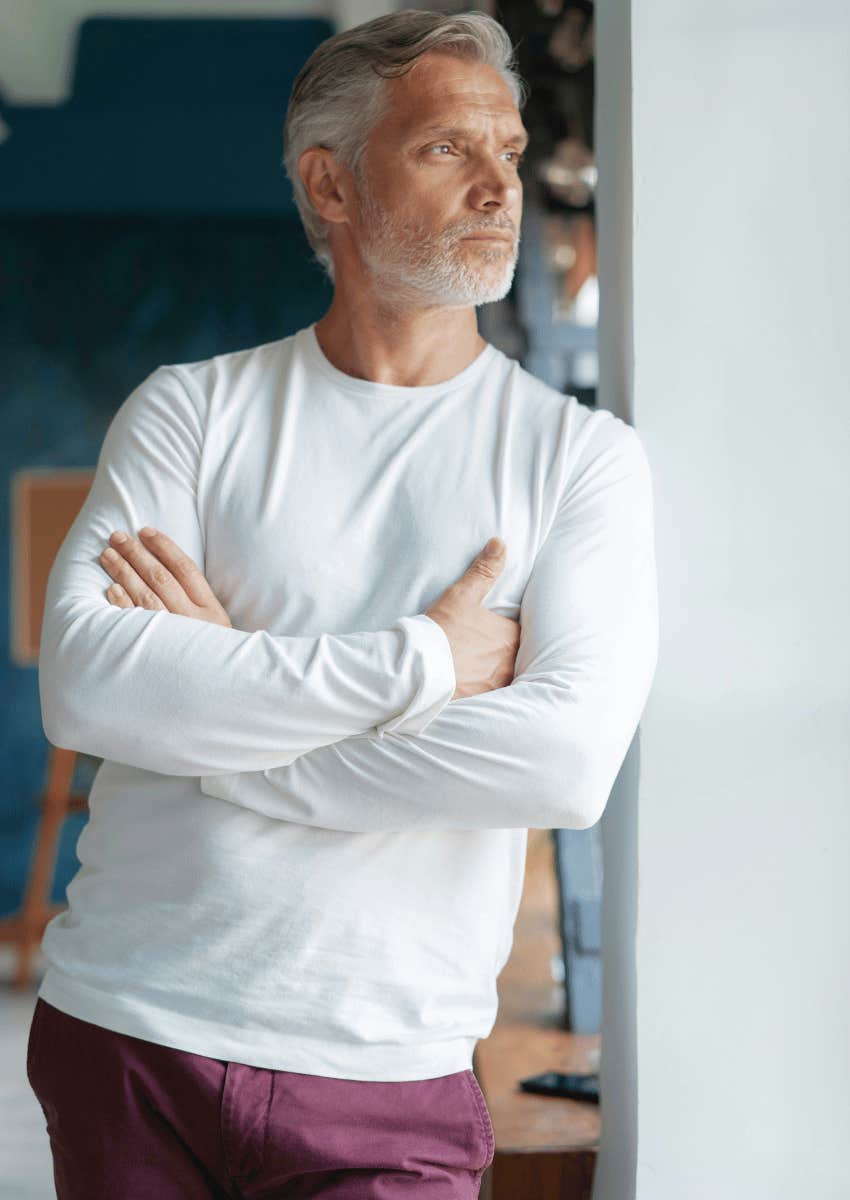 thoughtful middle age man looking out of window