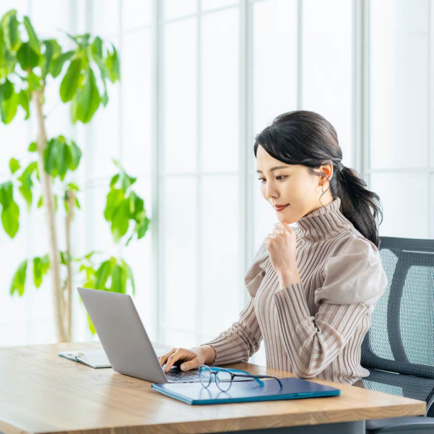 woman keeping her desk tidy hoping to be rich and successful