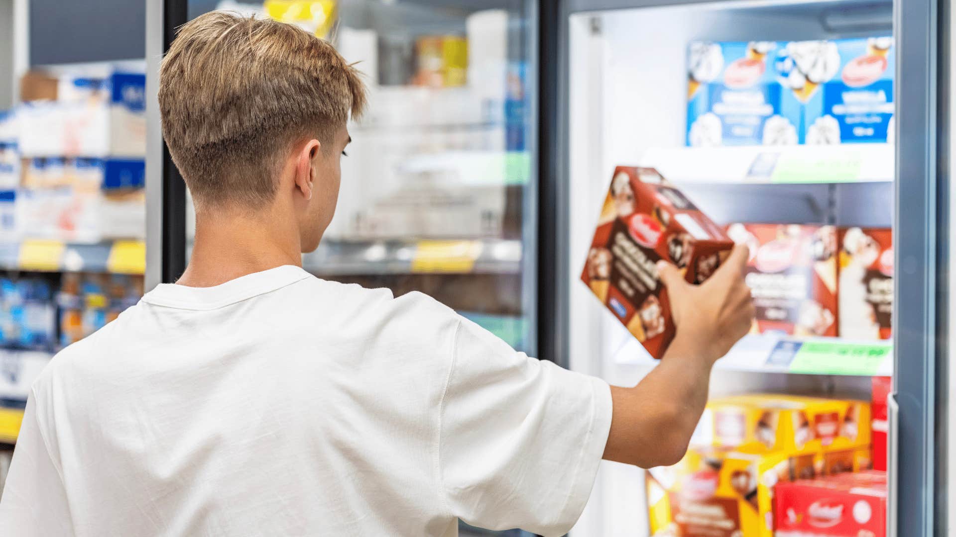 teenage boy shopping for food at the corner store
