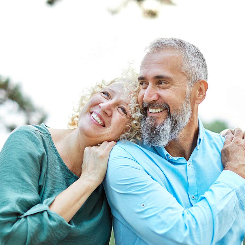 gen x couple embracing smiling about being in love