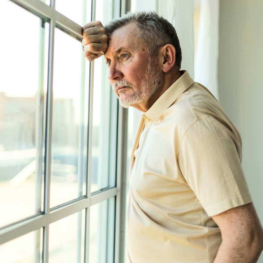 man who is way too independent staring out the window alone