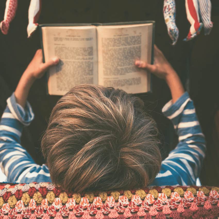vintage style photo of young boy reading book