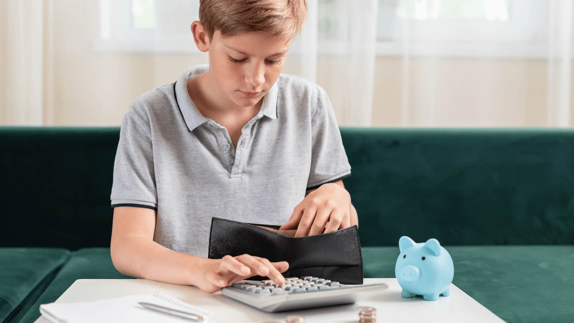 young boy learning the value of money counting coins