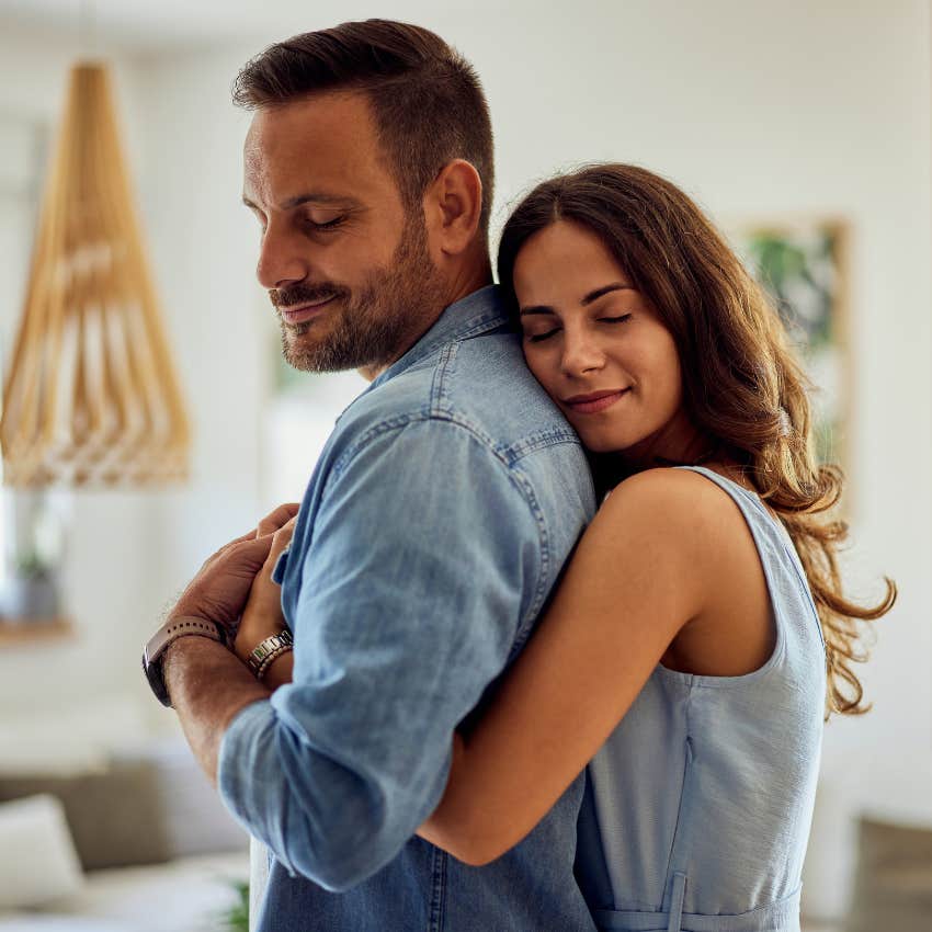 happy couple in good relationship offering support hugging