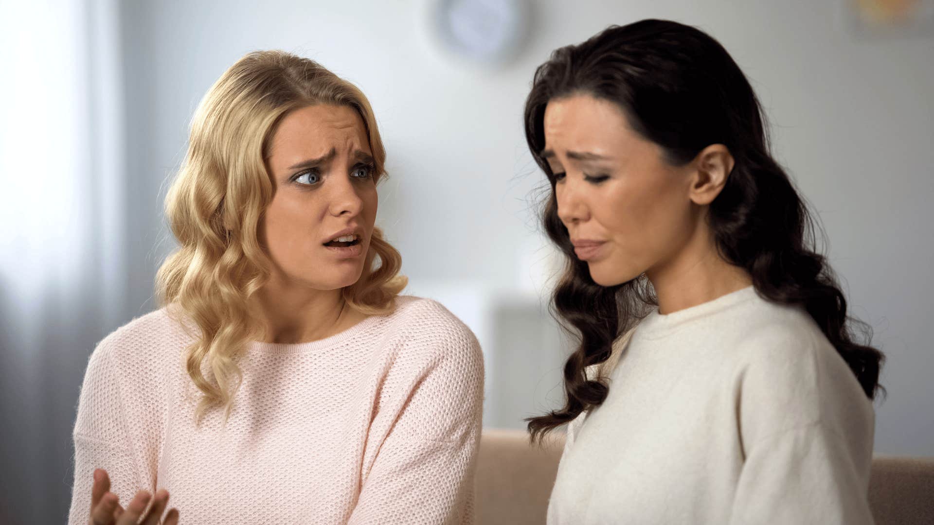 woman talking to friend whose life is falling apart looking upset