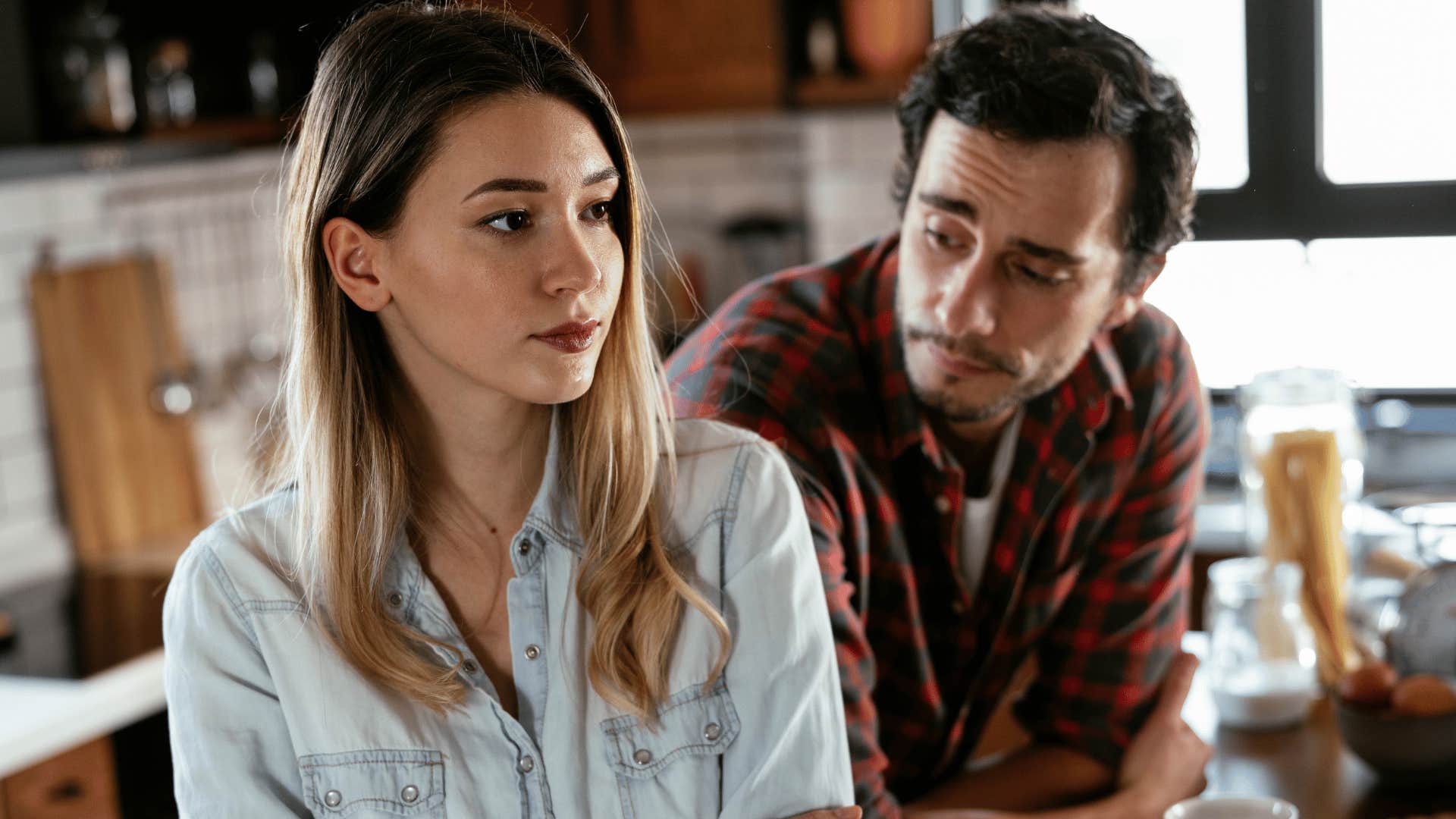 man trying to talk to sad partner telling him i can't focus right now
