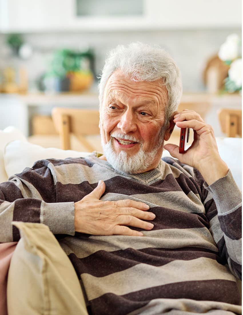 man in stripped shirt on phone saying lay it on me as he smiles