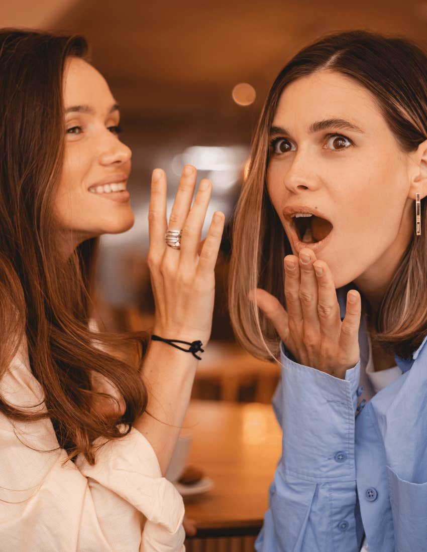 friends gossiping as friend in white shirt says no cap