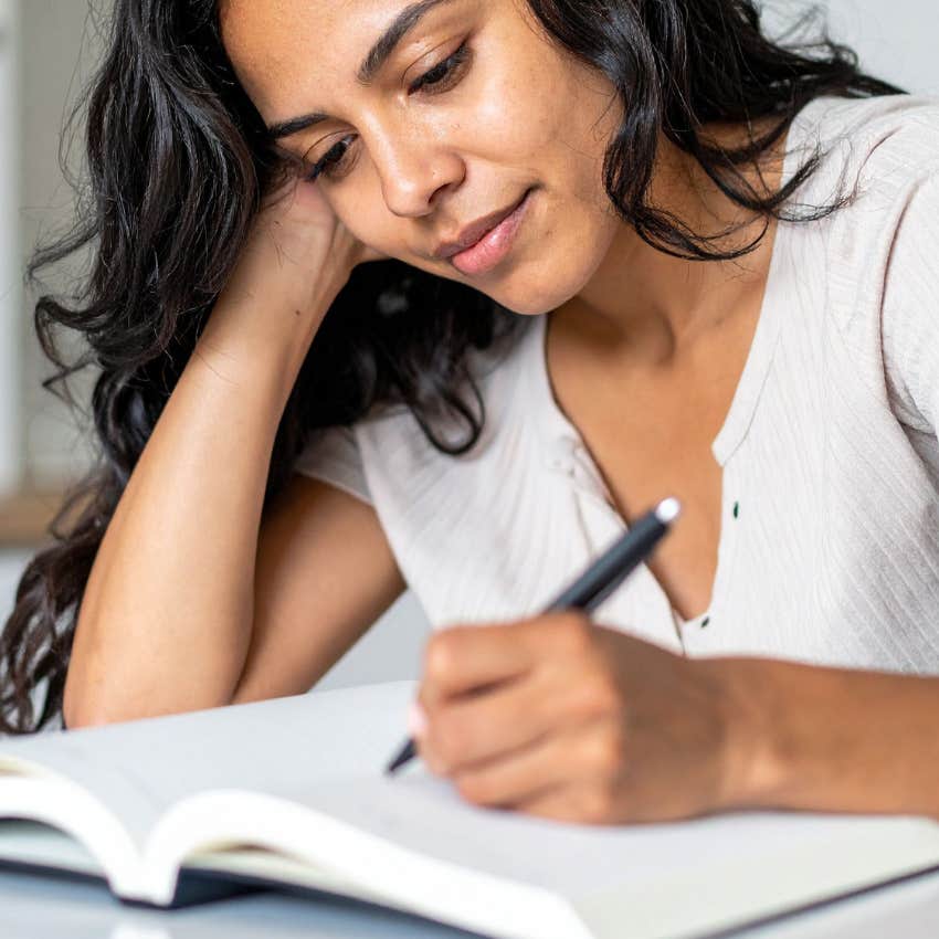 woman journaling regularly to work through her emotions