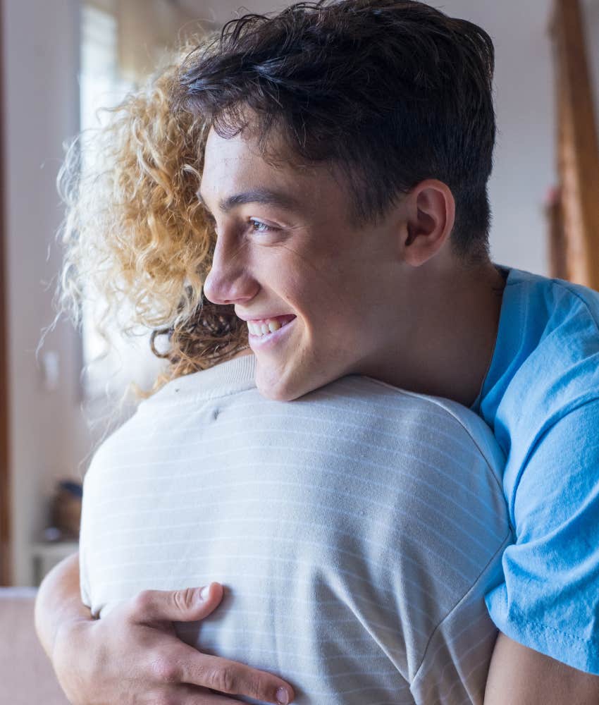 Young man who is great at reading a room shows empathy with a hug