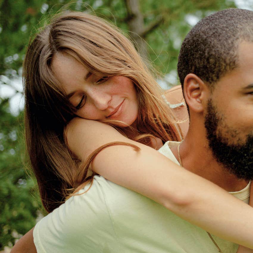 young woman seeking affection from man