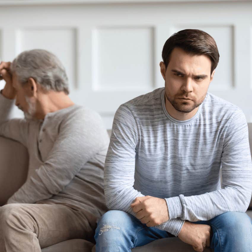 annoyed young man turned away from older man