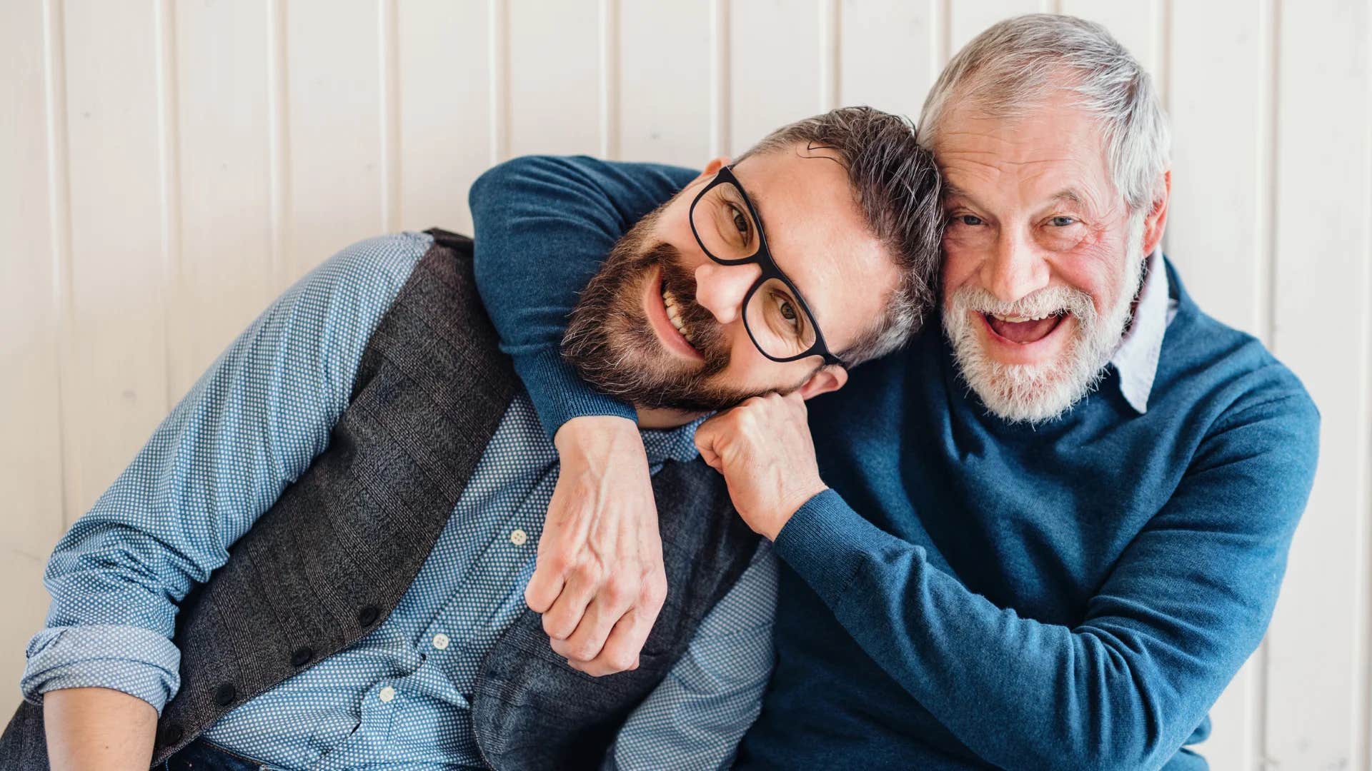gen Z man and his father joking around rough-housing