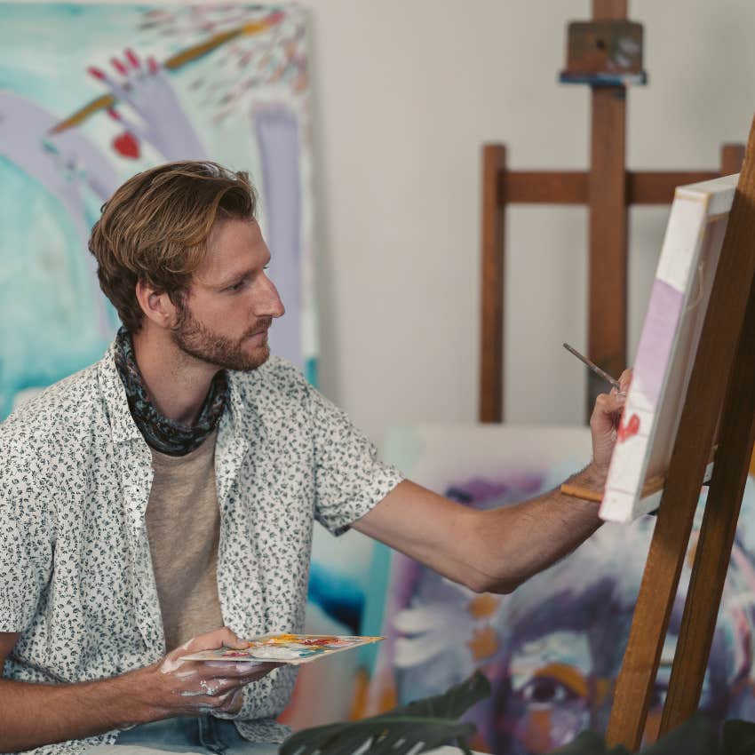 creative man painting in his art room