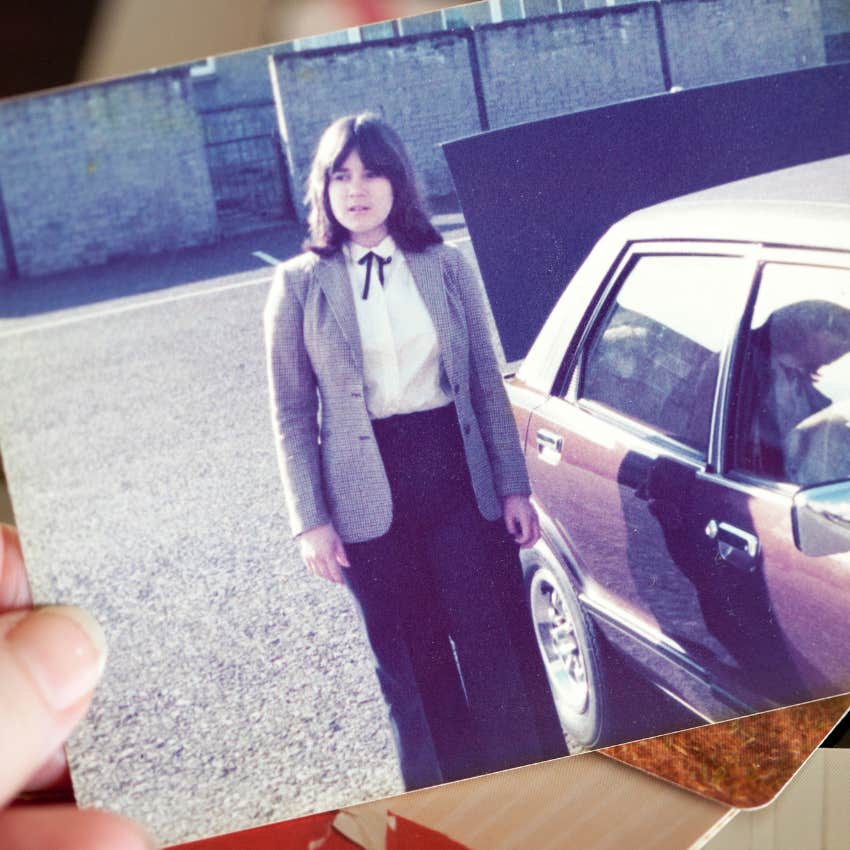 Gen X teenager beside car while taking driver's education