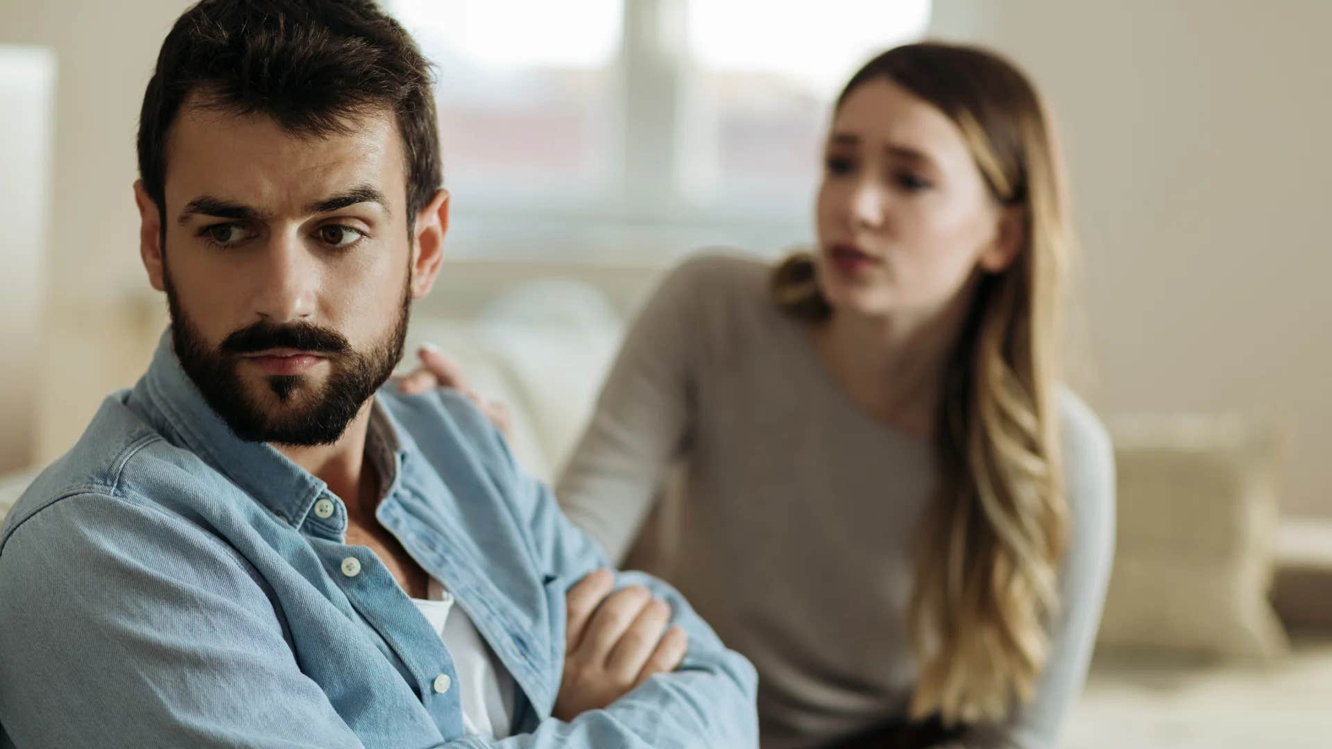 upset woman trying to talk to husband ignoring her