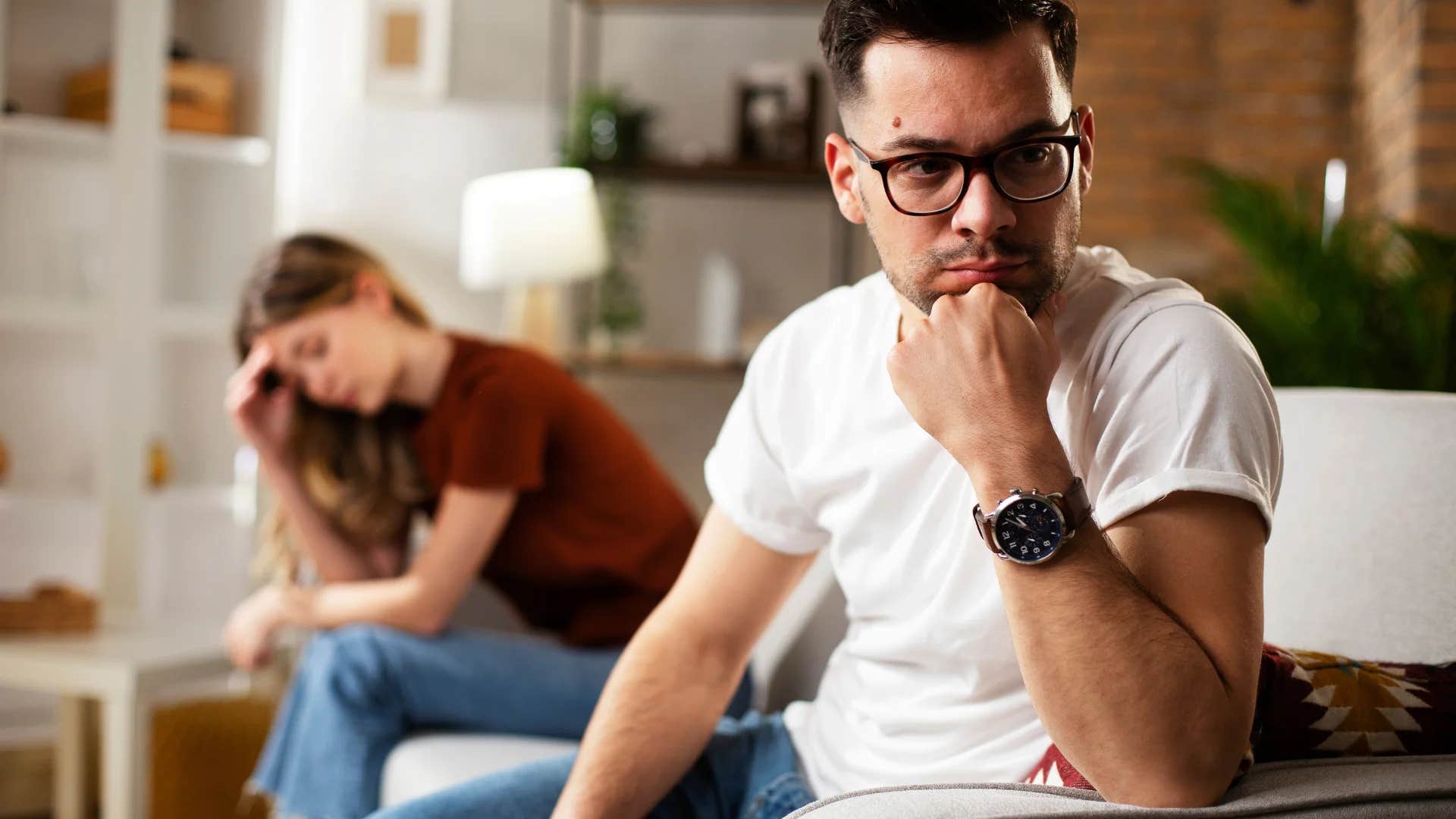 unhappy couple with man turned away during a conversation