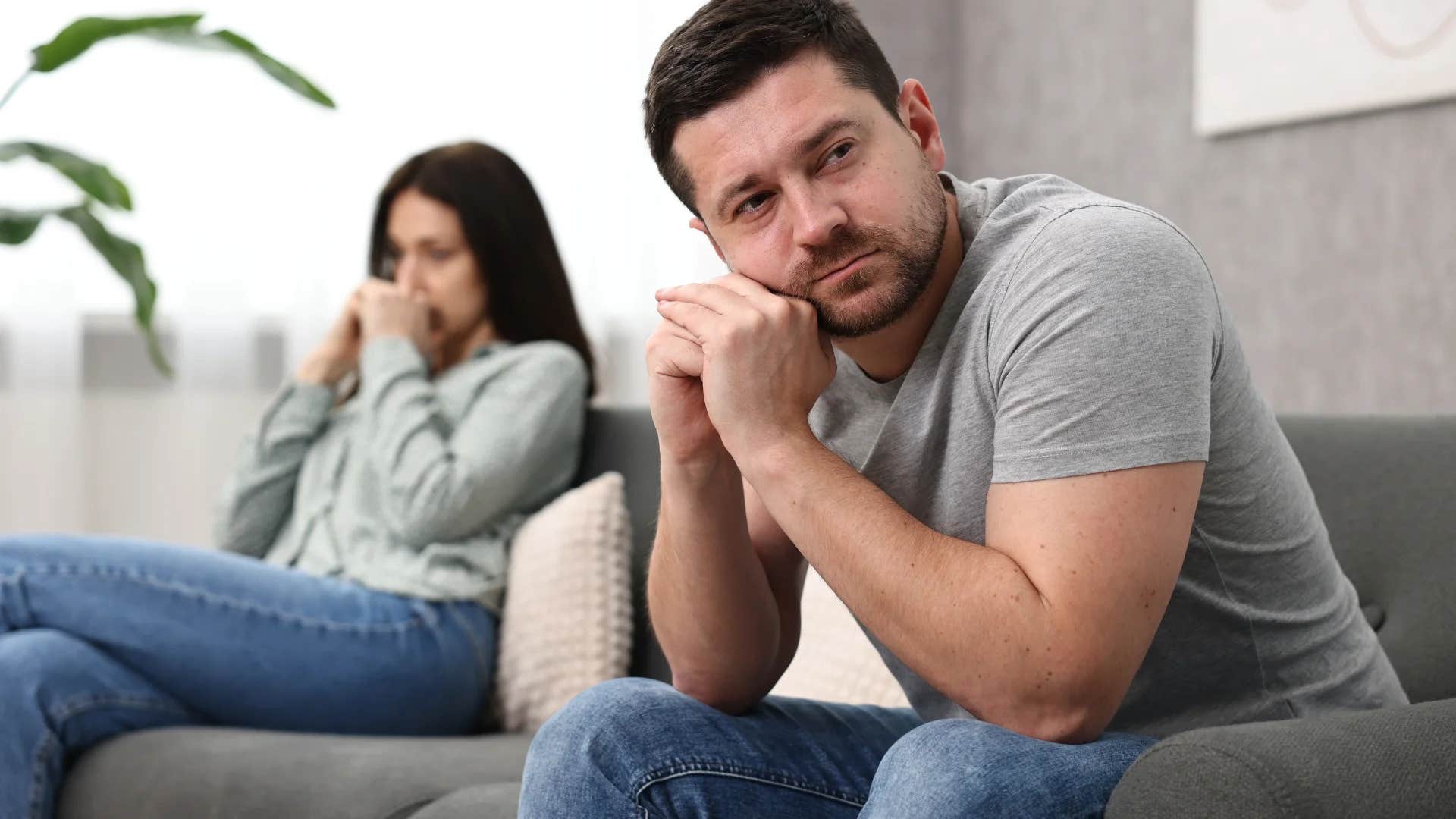 unhappy couple sitting apart from each other 