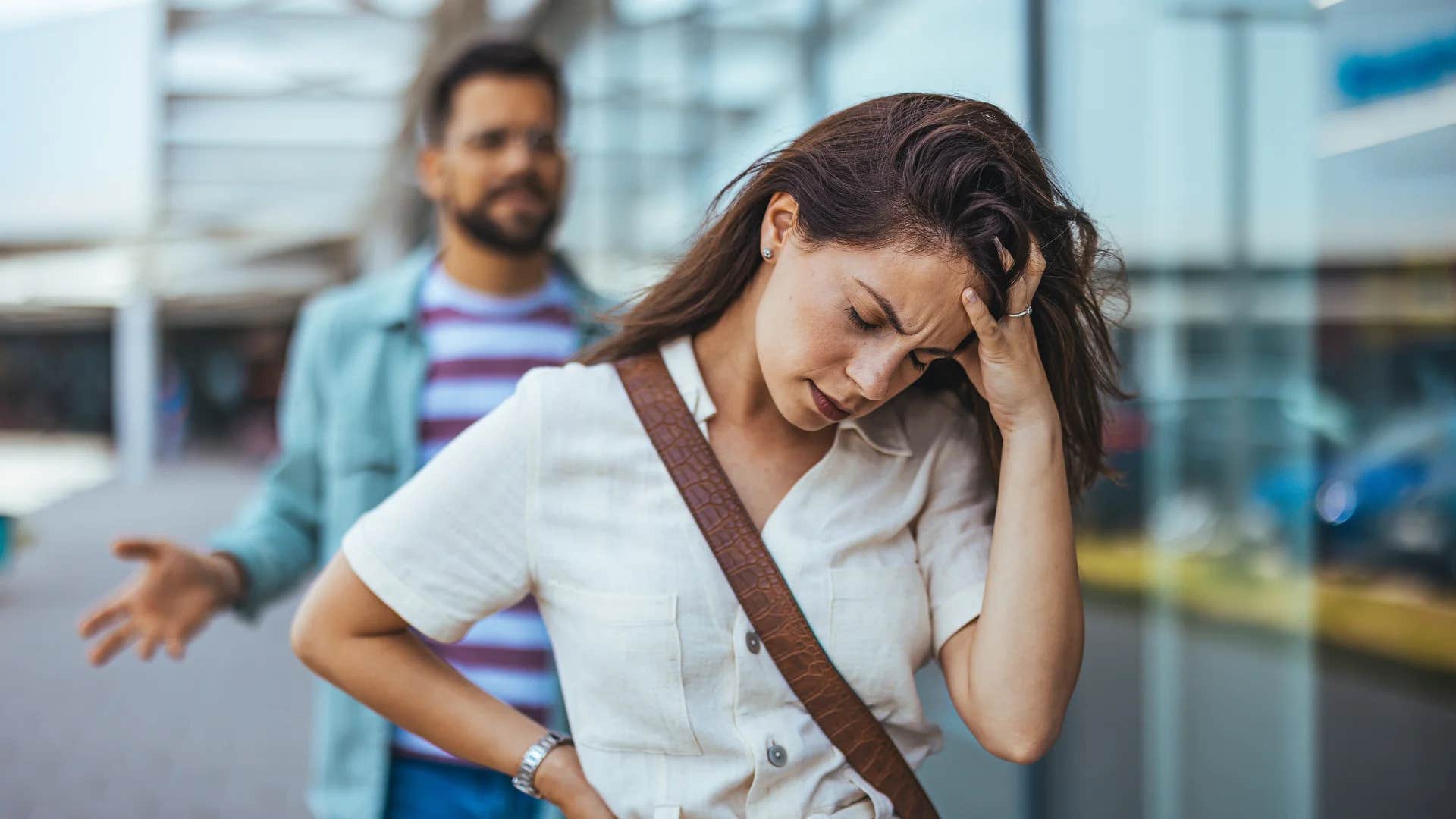 woman walking away from husband thinking it's better to be unhappy than alone
