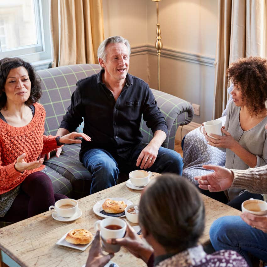 woman trying to explain what her husband is saying to their friends