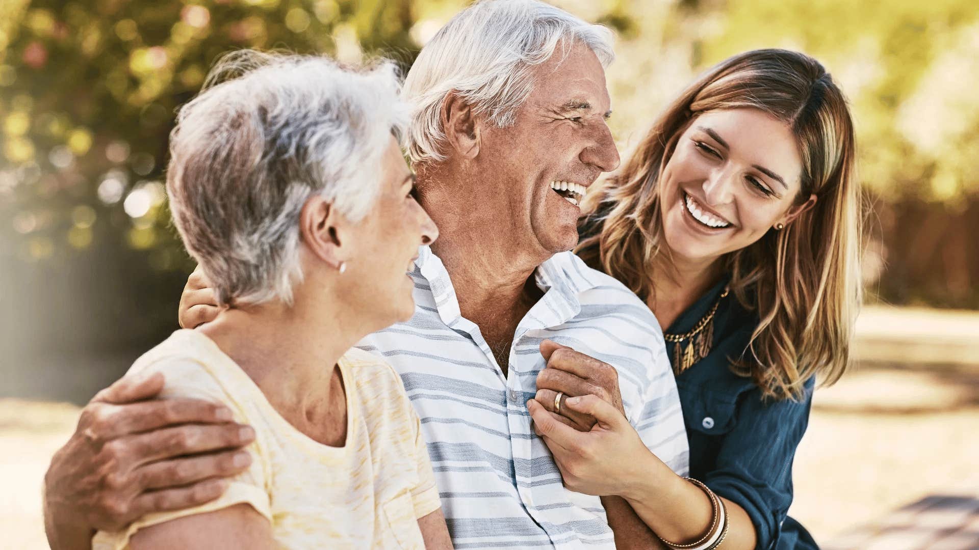 adult woman smiling with her confident parents in conversation