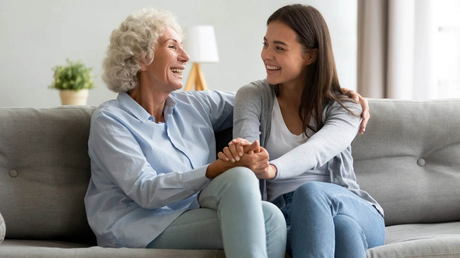 smiling older woman listening intently to her daughter talk