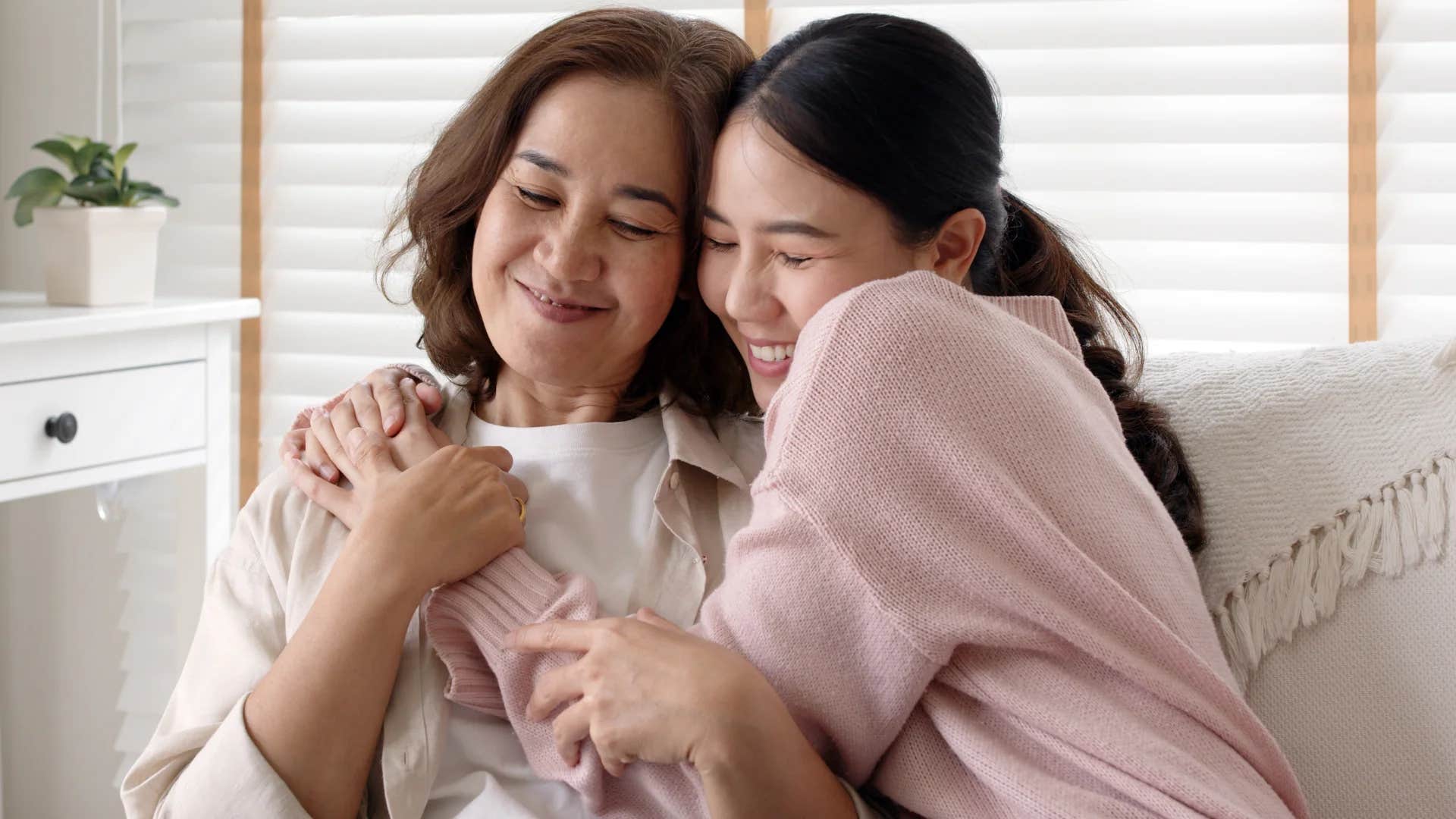 open-minded parent hugging her adult daughter